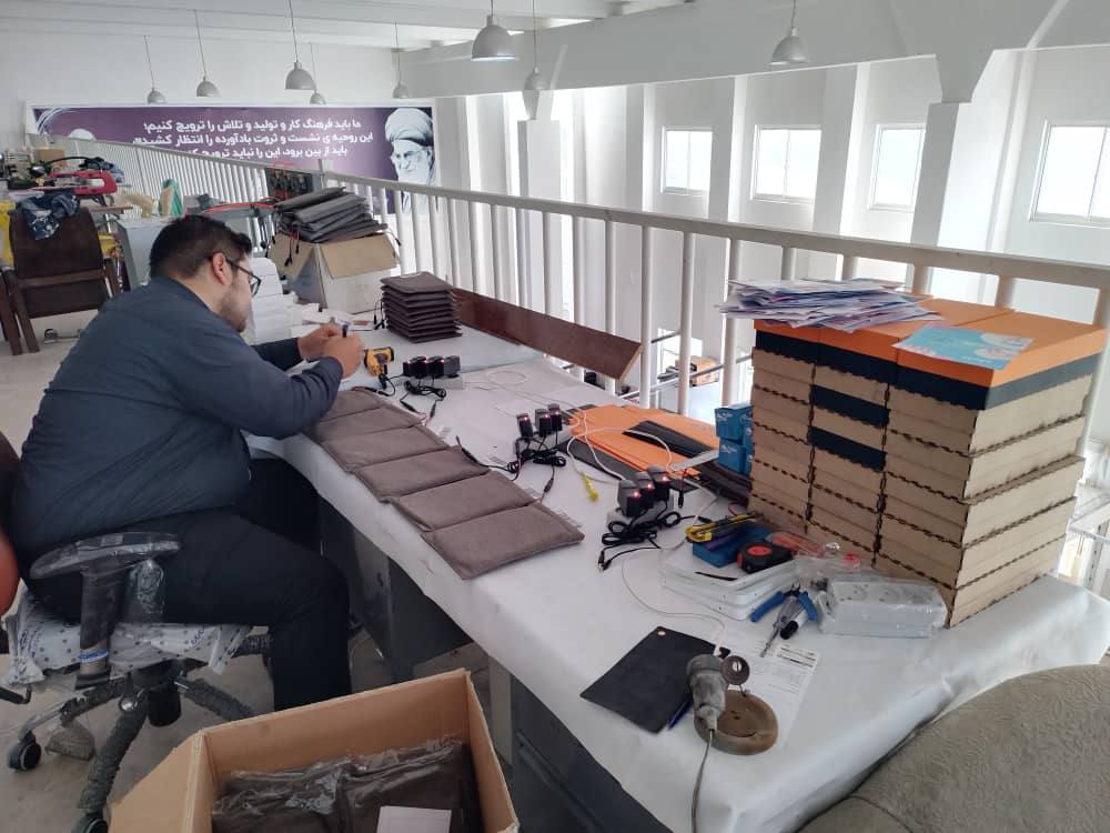 BizPet heating-pad production line — assembly and testing at the workbench
